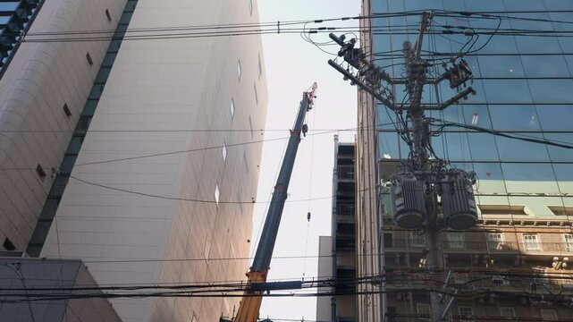 Mobile crane at downtown construction site in Osaka city Japan.