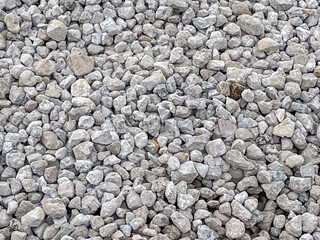Gravel, natural texture, construction material, gray tones, copy space.