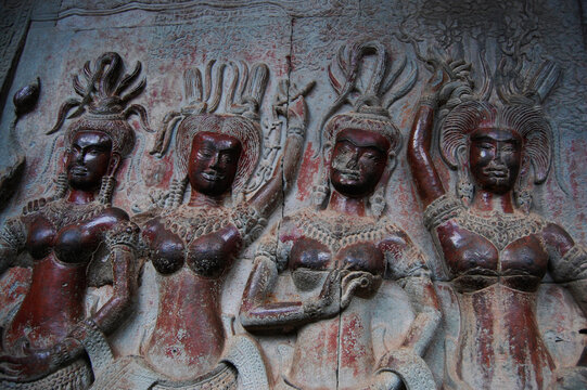 Sculpture carving figure apsaras or apsara angel deity female spirit of clouds and waters elegant and superb art of dancing in Hindu and Buddhist culture on wall of Angkor wat at Siem Reap, Cambodia