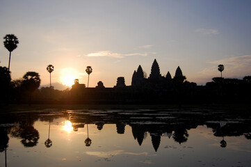 Naklejka premium Ancient ruins antique building castle Khmer Empire of Angkor Wat city temple for cambodian people foreign travelers travel visit respect praying and looking landscape sunrise in Siem Reap, Cambodia