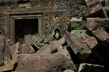 Naklejka premium Sculpture carving figure apsaras or apsara angel deity female spirit of clouds waters and superb art of dancing in Prasat Ta Prohm or Ancestor Brahma temple of Angkor Thom Wat in Siem Reap, Cambodia