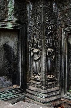 Sculpture carving figure apsaras or apsara angel deity female spirit of clouds waters and superb art of dancing in Prasat Ta Prohm or Ancestor Brahma temple of Angkor Thom Wat in Siem Reap, Cambodia