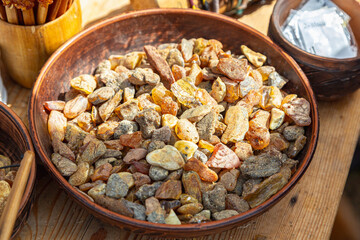 A detailed close-up of assorted polished and unpolished amber stones, showcasing their rich colors and textures.