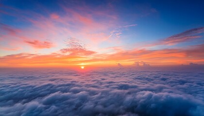 Fototapeta premium breathtaking sunrise above sea of fluffy clouds vibrant colors paint sky shades of orange pink and blue creating serene and awe inspiring atmosphere highlighting beauty of natures daily spectacle