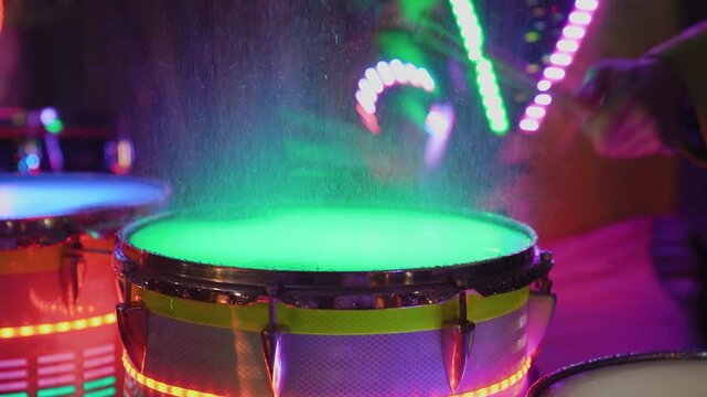 Drums with colored lighting at a performance