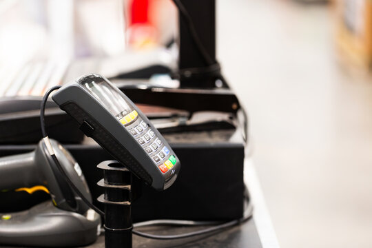 Copy space beside point of sale pin pad card reader at shop checkout