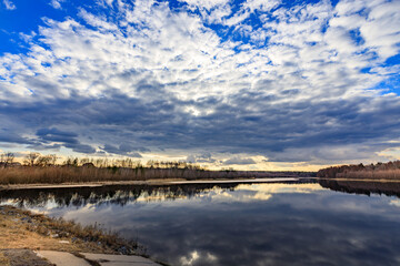 A cloudy sky with a lake in the background