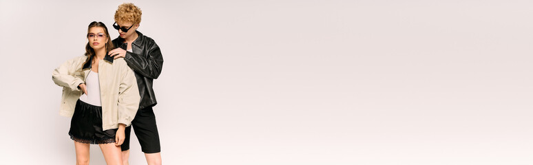 Stylish young couple enjoying a playful moment in modern trendy outfits with vibrant energy