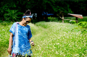 Thai woman portrait with spanish needle flower field
