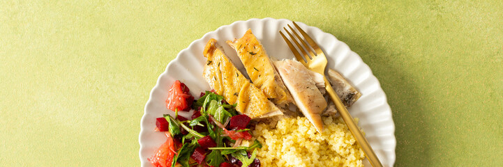 A nutritious and balanced breakfast with millet, baked chicken breast, a fresh salad with greens and grapefruit, providing protein, fiber, and vitamins for energy, banner