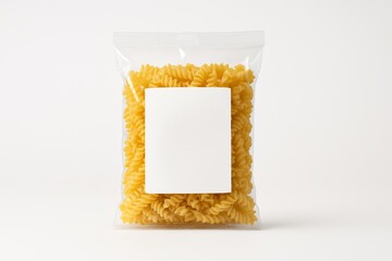 Package of dried fusilli pasta. Clear bag of uncooked spiral pasta with blank label.