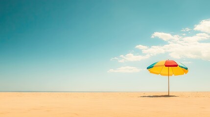 Colorful beach umbrella on sandy shore under blue sky summer vacation vibe