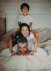happy family lying on bed
