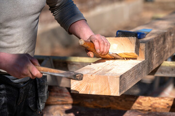 Craftsmanship in action with wood carving at a construction site during sunny day