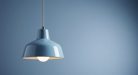 Obraz premium Pendant Light Fixture with Blue Shade and Metal Cord Hanging Against Soft Blue Background