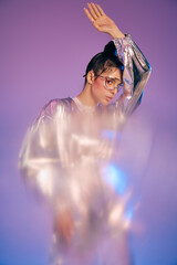 Stylish woman showcasing holographic fashion in a vibrant futuristic setting