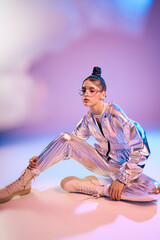Stylish woman showcases holographic fashion in a vibrant futuristic setting