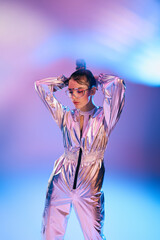 Stylish woman showcasing futuristic fashion in vibrant holographic colors