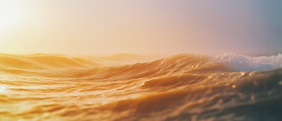 Sunlit ocean waves crest and fall, their surface glowing with a golden hue, embodying the serene dance of nature's timeless beauty.