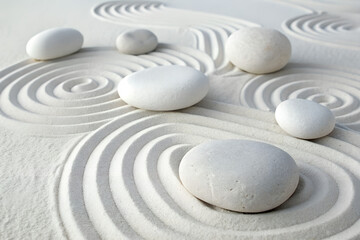 White smooth stones create abstract composition. Stones with intricate patterns, various shapes. Light and shadow enhances texture and depth. Zen, spa, wellness concept