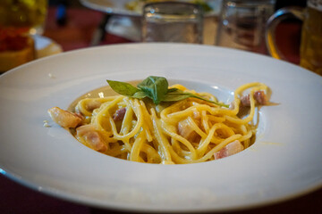 spaghetti carbonara with bacon on the white plate