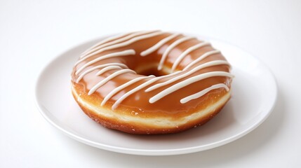 Beautifully glazed donut on a white plate, adorned with a drizzle of white icing