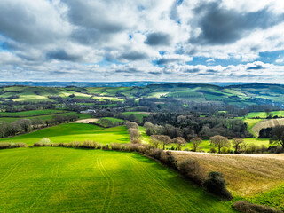 Obraz premium Farms over Road A35 from a drone, Morcombelake Village, Bridport, Dorset, England