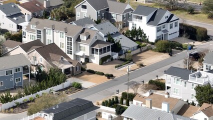 Aerial view of Virginia Beach, VA real estate beach front homes and vacation rentals along the peaceful ocean front coastline with coastal sand dunes