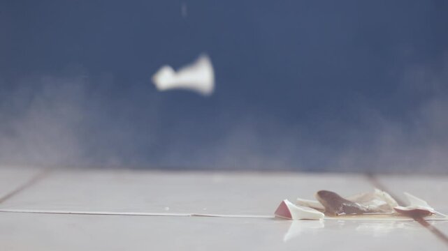 Cup of tea hitting the ground breaking