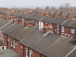 Aerial view above rows of back to back terraced houses on a large council estate