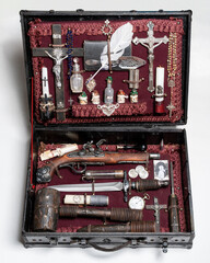suitcase with all the accessories for hunting vampires. Hammer with wooden stake, silver crucifix, garlic