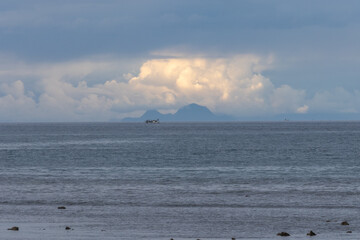 The row of high mountains on Flores Island is clearly visible from Waingapu on Sumba Island