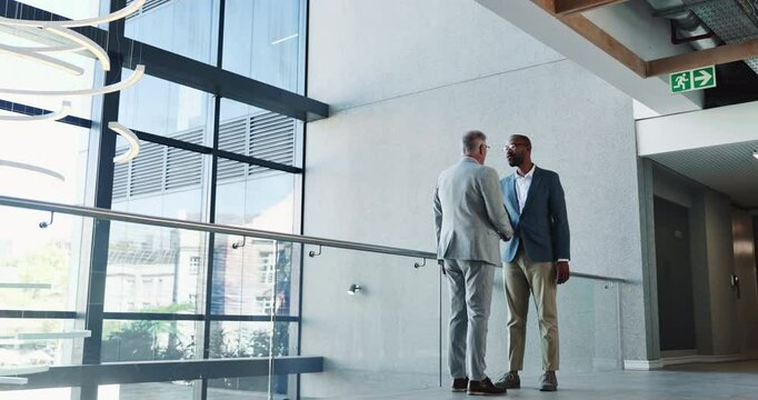 Handshake, meeting and partnership with business people in office for friendly greeting. Deal, hello or welcome with happy colleagues shaking hands in hallway of convention center for conference