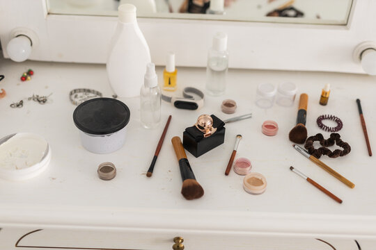 Messy vanity table with scattered beauty products and accessories. Make-up concept