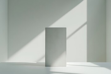 Minimalist white room with sunlight and rectangular podium for product display, presentation
