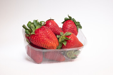 strawberries in a glass bowl, strawberries on white background. strawberries in the foreground with white background	