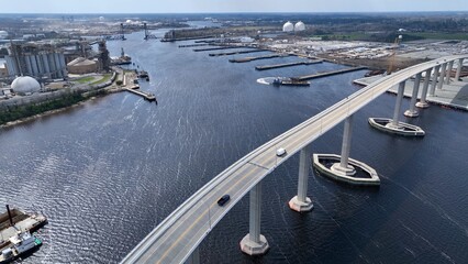 Cars crossing Elizabeth river at Norfolk Naval Shipyard in Portsmouth, Virginia showing industrial...