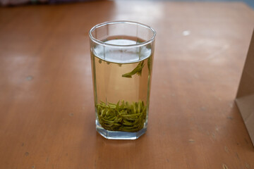 Glass of freshly brewed Longjing (龙井 Dragon Well) green tea