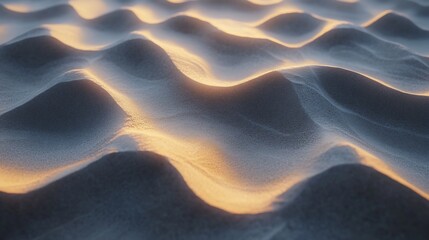 Golden desert dunes at sunrise.  Gentle ripples of sand illuminated by the rising sun