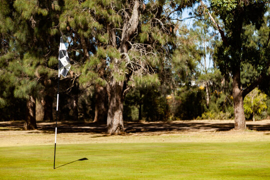 Golf flag in hole on golfing green