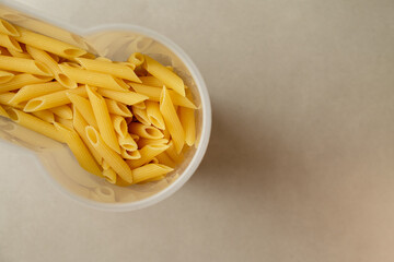 Pasta in a clear container awaiting a delicious meal preparation