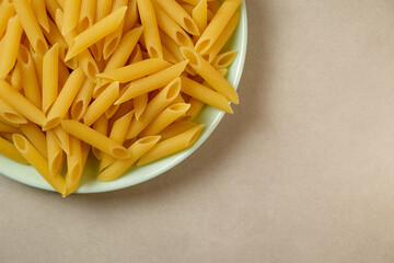 Penne pasta artfully arranged on a pastel plate for inspiration