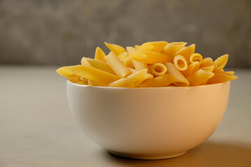 Delicious dried pasta in a charming bowl with a soft background