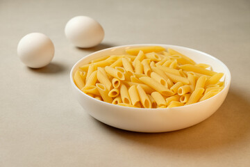 Delicious pasta awaiting preparation with fresh eggs nearby