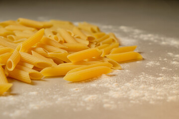 Pasta scattered on a kitchen surface with a dusting of flour