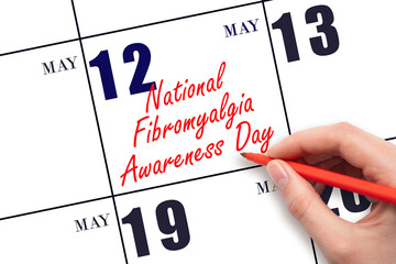 May 12. Hand writing text National Fibromyalgia Awareness Day on calendar date. Save the date.