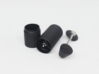 Close-up photo of three components of a manual hand grinder for black coffee isolated on white background