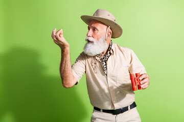 Photo of shocked eco tourist scientist hold hand product from wildlife wear safari suit isolated green color background