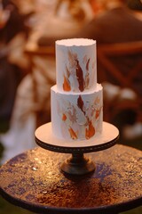 Elegant Two-Tiered Wedding Cake Displayed on a Rustic Stand
