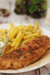 Fish and chips served on the plate, traditional dish of Great Britain	